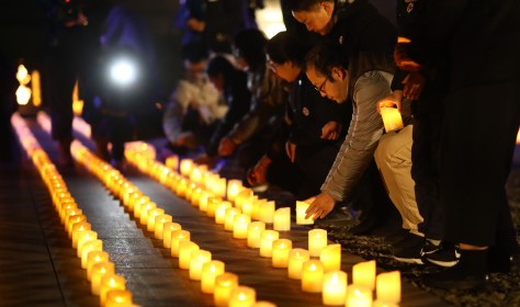 People put down candles at Nanjing Massacre memorial