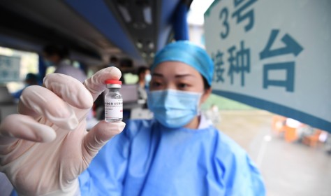 A medical worker shows the COVID-19 vaccine