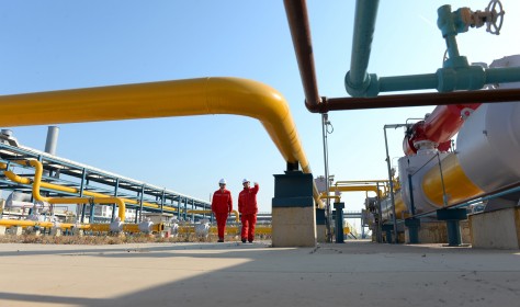 Technicians inspect pipelines at a liquefied natural gas (LNG) terminal operated by China Petrochemical Corporation (Sinopec Group)