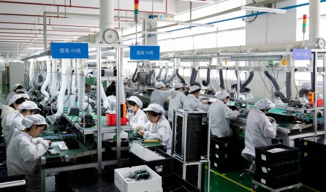 Workers work on a production line to produce electrical products for domestic and Southeast Asian markets in Nantong