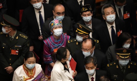 Delegates leave after the closing session of China's National People's Congress (NPC)