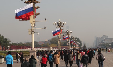 Chinese and Russian national flags flutter on lampposts in front of the Tian'anmen Rostrum