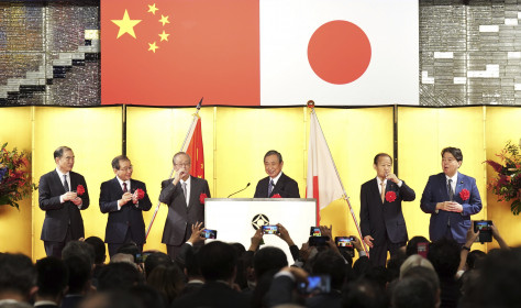 On the stage from left, the Chinese ambassador to Japan Kong Xuanyou, Chairman of the Japan Business Federation Masakazu Tokura, former Japan's Prime Minister Yasuo Fukuda, Head of the Japanese Association for the Promotion of International Trade Yohei Kono, Japan's ruling Liberal Democratic party's politician Toshihiro Nikai and Japanese Foreign Minister Yoshimasa Hayashi toast during a reception to mark the 50th anniversary of Japan-China diplomatic relations Thursday, Sept. 29, 2022, in Tokyo.