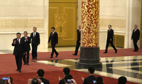 New members of the Politburo Standing Committee, from left, President Xi Jinping, Li Qiang, Zhao Leji, Wang Huning, Cai Qi, Ding Xuexiang, and Li Xi arrive at the Great Hall of the People in Beijing, Sunday, Oct. 23, 2022.
