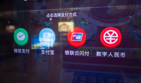 Residents buy drinks at a vending machine by scanning the code of a digital RMB wallet. at Nanjing East Road subway station in Shanghai, China, Feb. 24, 2021.