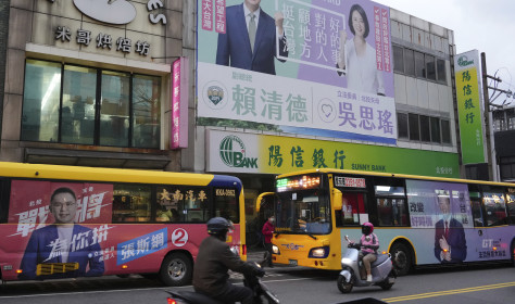 Candidates' posters of the Taiwanese presidential election are hung on a building wall in Taipei on Dec. 21, 2023.