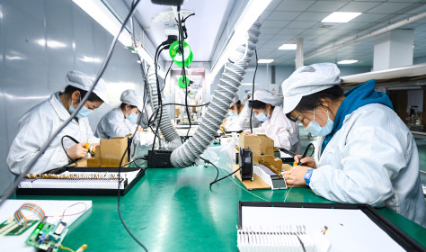 Workers make liquid crystal displays and modules on the production line at a semiconductor production workshop in China