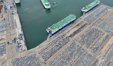 Car carriers load cars for export at Yantai Port in Yantai, Shandong province, China, July 2024.