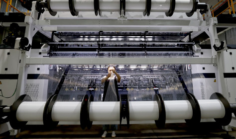 A worker makes lace products on a production line at a smart textile production workshop in Fuzhou, Fujian province, China, Sept 20, 2024.
