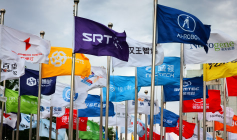 actory flags of famous Chinese enterprises flutter in the wind under the blue sky in front of the square of the permanent site of the Zhongguancun Forum in Beijing, China, May 14, 2024.