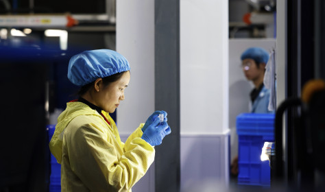 A worker produces new materials for high-end special-shaped anti-counterfeiting bottle caps at a workshop of Sihong Economic Development Zone in Suqian, Jiangsu province, China, November 13, 2024.
