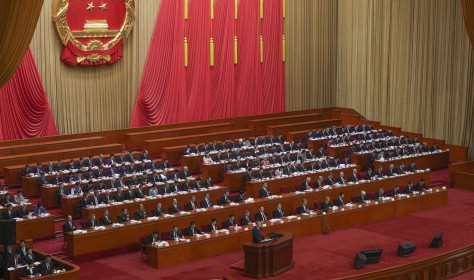 Chinese Premier Li Qiang speaks from a lectern during the opening session of the National People's Congress (NPC) at the Great Hall of the People in Beijing, China, Wednesday, March 5, 2025. 