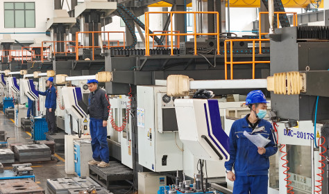 Workers produce slitting machine parts at Qingdao Kaisheng CNC Equipment Co., LTD., in Qingdao, Shandong province, China, November 28, 2024