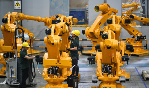 Workers assemble industrial robots at a robot manufacturer in Nanjing city in east China's Jiangsu province.