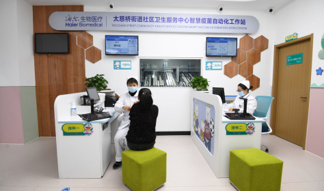 At the Smart Vaccine automation workstation of the community Health Service center, medical staff inoculate people with the nine-valent HPV vaccine in Guiyang, Guizhou province, China, March 14, 2024.