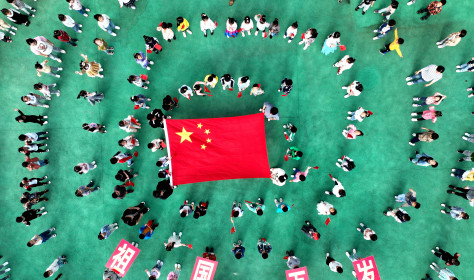 Kindergarten children pose with national flags in Lianyungang, Jiangsu province, China.