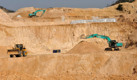 Workers use machinery to dig at a rare earth mine in Ganxian county in central China's Jiangxi province on Dec. 30, 2010.