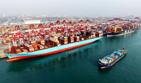 A cargo ship is loading and unloading foreign trade containers at the Qingdao Port Automated Terminal in Shandong Province, China on January 14, 2026
