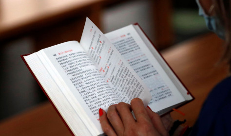 Woman reading a chinese bible.