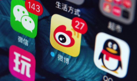 Icons of the messaging apps Weixin (WeChat), left, QQ, right, and Weibo, center