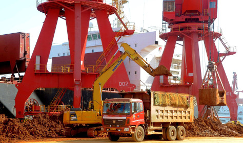 -An excavator loads a truck with rare earth on a quay at the Port of Lianyungang in Lianyungang city, east Chinas Jiangsu province, 10 March 2013.