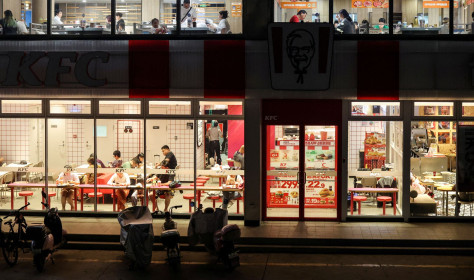Customers dine inside a two-storey restaurant complex housing a KFC outlet on the ground floor and other restaurants on the upper floor in Beijing, China, July 12, 2026. REUTERS/Maxim Shemetov