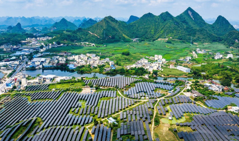 A vast array of deep-blue solar panels stretches across karst mountains at the Hongqi photovoltaic power base in Dahua Yao Autonomous County, Hechi, south China's Guangxi Zhuang Autonomous Region, Sept. 9, 2026, blending with scattered homes and farmland. (Photo by Imaginechina/Sipa USA)