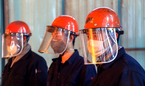 Chinese workers survey the production of steel at a plant of Qingdao Special Iron and Steel Co., Ltd. in Qingdao city.