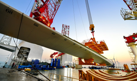 This photo taken on Jan. 13, 2026 shows one of the turbine blades being hoisted at the construction site of a 20-megawatt offshore wind turbine unit in the coastal waters of southeast China's Fujian Province. 