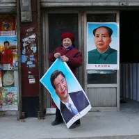 Portraits of Mao and Xi on posters