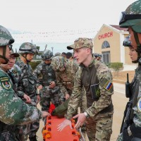 Chinese and Russian soldiers communicate with each other during a joint exercise