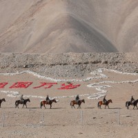 Border guards climbed over the obstacle on horseback. Kashgar City, Xinjiang 