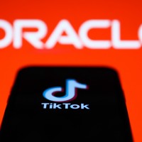 Logos of TikTok and Oracle