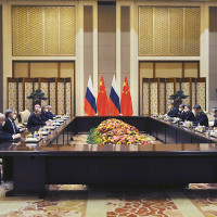 Chinese President Xi Jinping, fourth right, and Russian President Vladimir Putin, fourth left, attend talks in Beijing, China, Friday, Feb. 4, 2022.