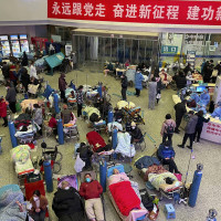 Patients, most of them elderly with covid symptoms, are crowded at the Changhai Hospital hall as they receive medical treatment, in Shanghai, China, Tuesday, Jan. 3, 2023