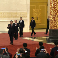 New members of the Politburo Standing Committee, from left, President Xi Jinping, Li Qiang, Zhao Leji, Wang Huning, Cai Qi, Ding Xuexiang, and Li Xi arrive at the Great Hall of the People in Beijing, Sunday, Oct. 23, 2022.