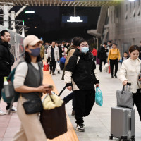  Passengers travel from Nanjing Railway Station in Nanjing, Jiangsu province, China, Feb 14, 2024.