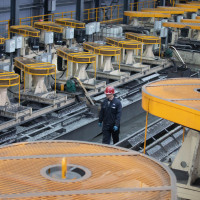 A man works in a workshop of a graphite company in Jixi City, northeast China's Heilongjiang Province, March 24, 2023. 