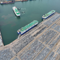 Car carriers load cars for export at Yantai Port in Yantai, Shandong province, China, July 2024.