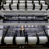 A worker makes lace products on a production line at a smart textile production workshop in Fuzhou, Fujian province, China, Sept 20, 2024.