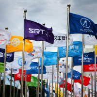 actory flags of famous Chinese enterprises flutter in the wind under the blue sky in front of the square of the permanent site of the Zhongguancun Forum in Beijing, China, May 14, 2024.