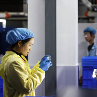  A worker produces new materials for high-end special-shaped anti-counterfeiting bottle caps at a workshop of Sihong Economic Development Zone in Suqian, Jiangsu province, China, November 13, 2024.