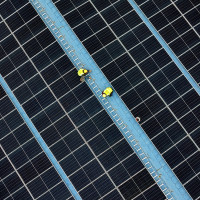 Construction workers install photovoltaic modules on the roof of Tongwei Electric Haian Co., LTD in Hai 'an, Jiangsu province, China, November 19, 2024.
