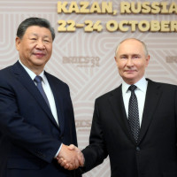 Russian President Vladimir Putin, right, welcomes Chinese President Xi Jinping, for the 16th BRICS summit at the Kazan Kremlin