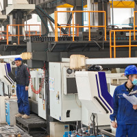 Workers produce slitting machine parts at Qingdao Kaisheng CNC Equipment Co., LTD., in Qingdao, Shandong province, China, November 28, 2024