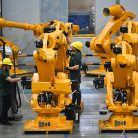 Workers assemble industrial robots at a robot manufacturer in Nanjing city in east China's Jiangsu province.