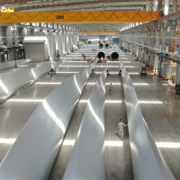 Employees inspect wind turbine blades at a workshop of Shanghai Aeolon Wind Energy Technologies Development (Group) Co Ltd. on May 13, 2020 in Nantong, Jiangsu Province of China.