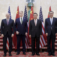 In this photo released by Xinhua News Agency, Chinese Vice Premier He Lifeng, center right, and U.S. Treasury Secretary Scott Bessent, center left, pose for a group photo with delegations before their meeting to discuss China-U.S. trade, in London, Monday, June 9, 2025.