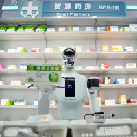 A Galbot humanoid robot plays the role of a shop assistant in a simulated pharmacy in Beijing Economic-Technological