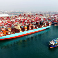 A cargo ship is loading and unloading foreign trade containers at the Qingdao Port Automated Terminal in Shandong Province, China on January 14, 2026